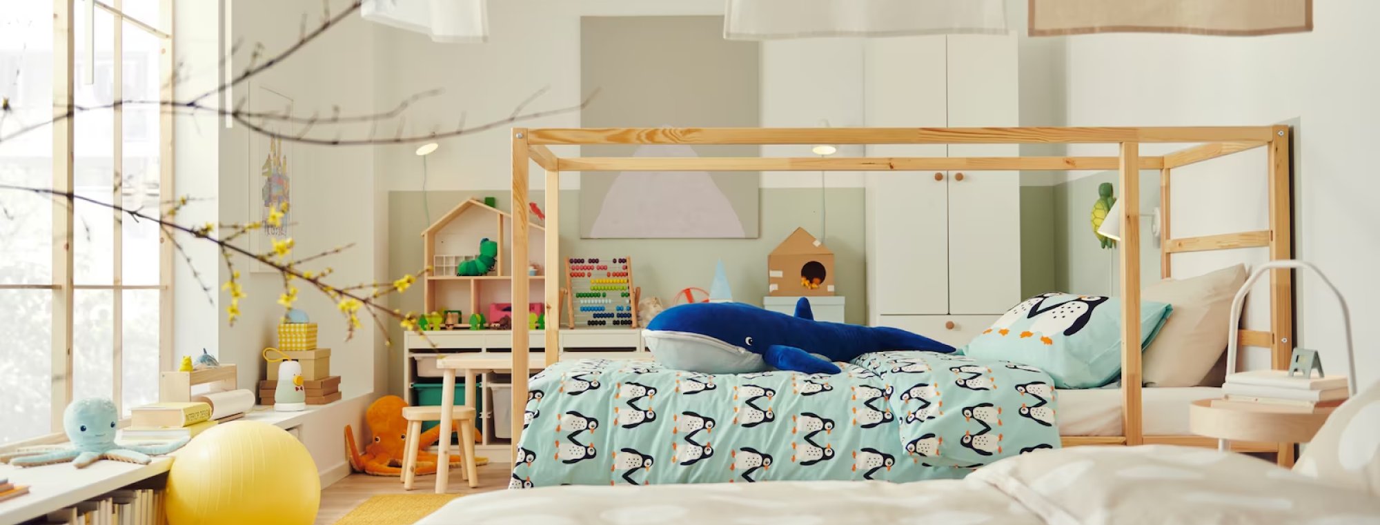 A kids bedroom with a bed, storage and more furniture