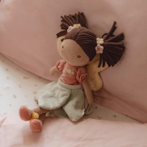 Little Dutch Fairy Doll Evi lying on a pink bed