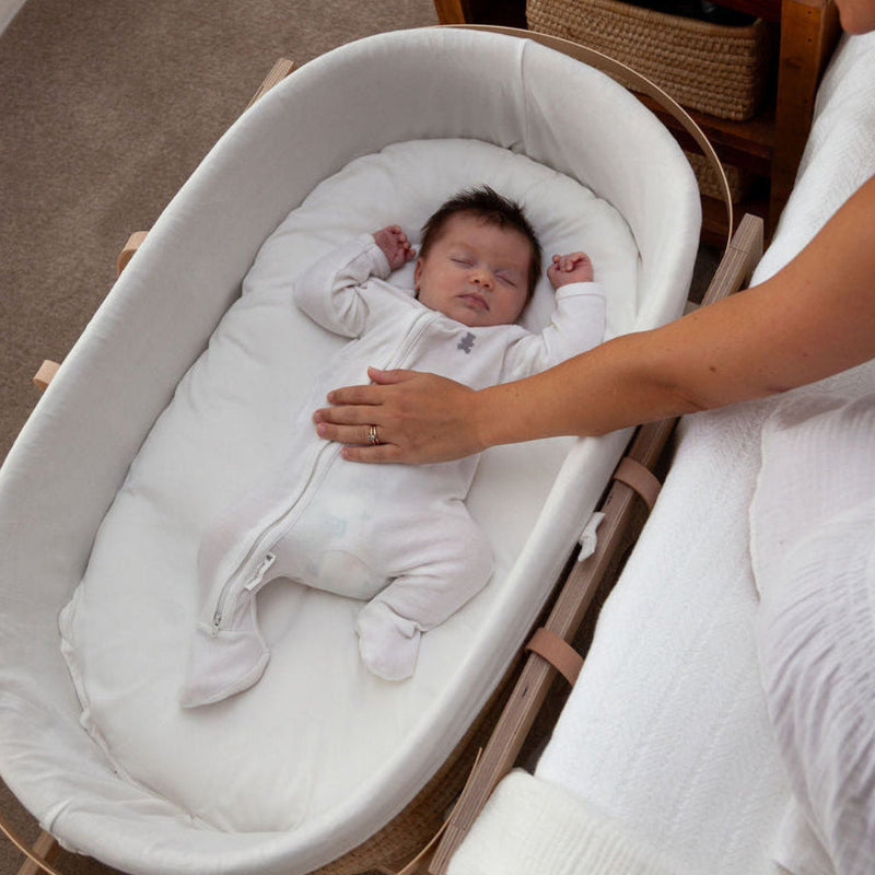 Ko-Coon slipcover on the mattress in a Moses basket