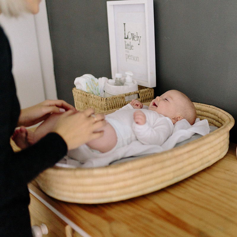 Ko-Coon changing basket in use on a dresser